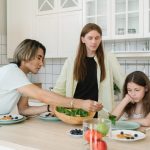A diverse family enjoys meal preparation and bonding in a stylish kitchen setting.